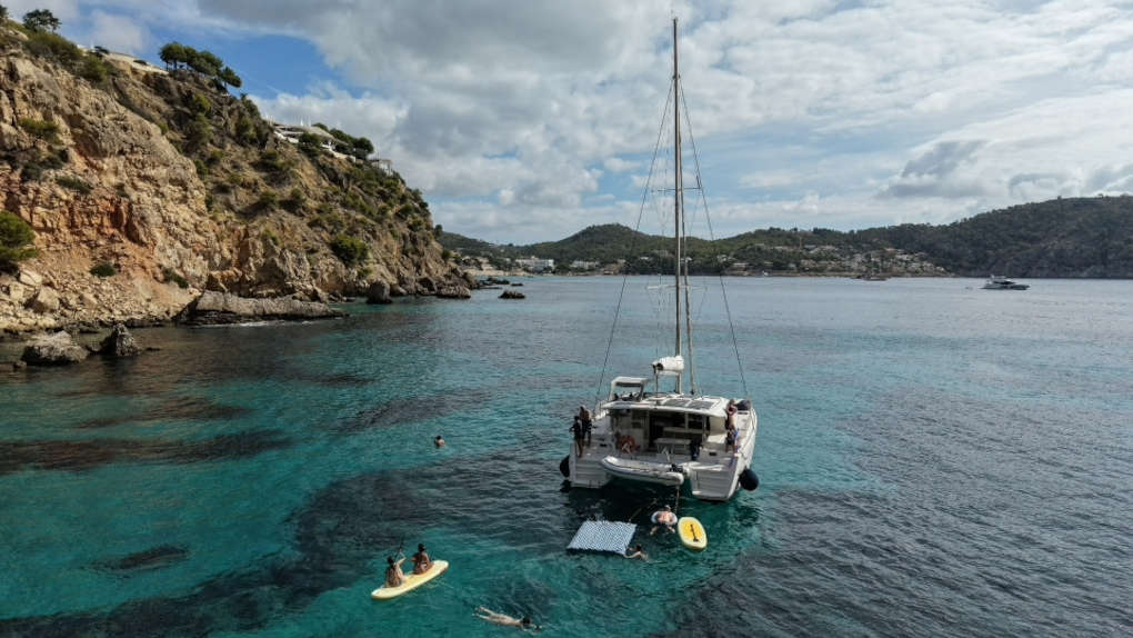 Salty Breeze aerial view with paddleboard with swimmer
